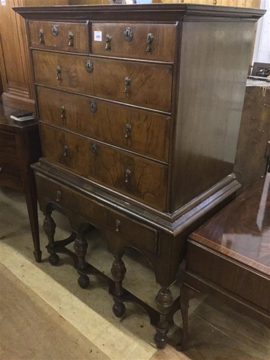 An 18th century walnut chest on later stand